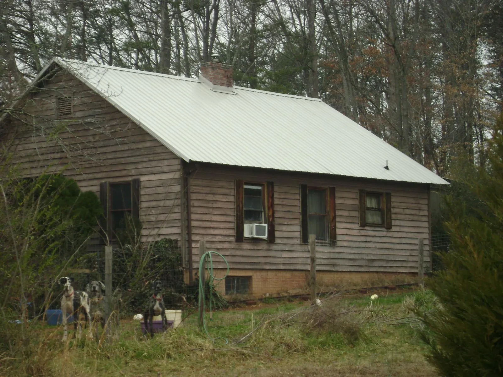 White metal roof on an old wood sided farmhouse, from a Metal Roof Installation job in New Bremen